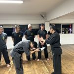 Instructor Dominique being presented with his new belt by Sifu Bruce